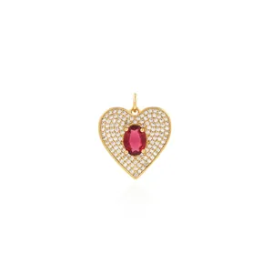 Detailed close-up of 18K gold-plated heart pendant with red stone and micro-pave crystals