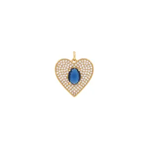 Close-up of 18K gold heart pendant with blue gemstone and micro-paved cubic zirconia
