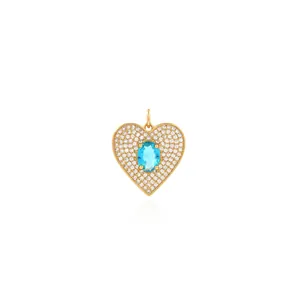 Macro view of 18K gold plated heart pendant with blue gem and pavé zircon stones