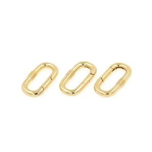 Macro detail of three 18K gold-plated oval carabiner spring clasps for jewelry making
