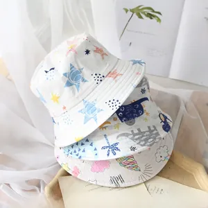 Detailed view of three cotton bucket hats with dinosaur, star, and ice cream patterns
