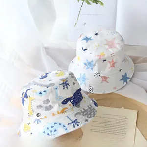 Detail of kids bucket hats featuring cute dinosaur and colorful star patterns
