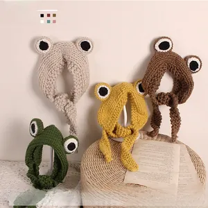 Detailed knit texture of frog-themed children hairbands in green, beige, and yellow colors