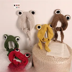 Detail of five-color big eye frog knit headbands for toddlers on a woven basket