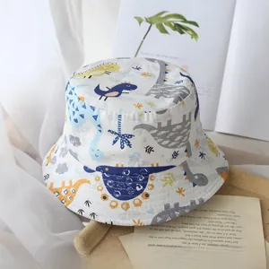 Detail of soft cotton kids sun hat featuring colorful cartoon dinosaur prints and wide brim