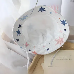Detail of white star print kids bucket hat featuring a flexible chin strap for sun protection