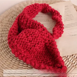Close-up of red thick knit ear warmer headband with textured wool for kids and babies