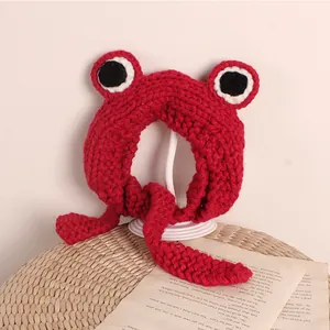 Handmade red knitted frog hat for children with large eye decorations and tie straps