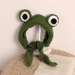 Handmade green knitted frog hat for toddlers with cute big eyes and secure chin straps