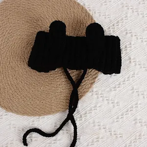 Black knitted baby winter hat with cute round ears and long chin straps for warmth