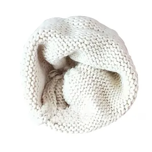 Detail of 100% acrylic knit texture and washing label on cream white baby beanie