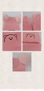 Close-up of pink knit hat with bear embroidery and thick white fleece lining texture