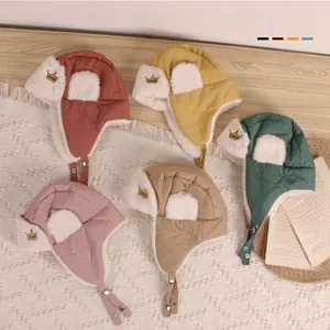 Detail view of colorful warm plush crown hats for kids in various winter tones