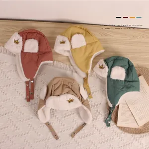 Detail of warm winter crown pilot hats for babies in four colors with faux fur lining