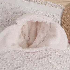 Close-up of cozy cream plush trapper hat showing soft faux fur texture and thermal lining