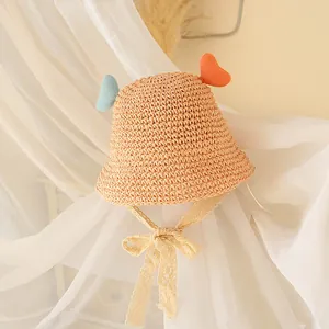 Straw sun hat for children featuring heart-shaped knit ears and floral lace neck straps