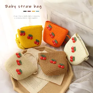Cute kids cherry straw bags in multiple colors with woven shoulder straps for girls