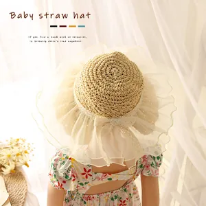 Light beige hand-woven baby straw hat with white organza ruffles and a cute bow detail