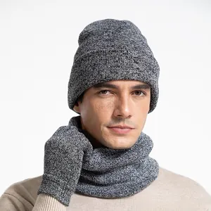 Close-up of grey knit winter set featuring a beanie hat, neck warmer, and gloves on model