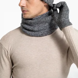 Close-up detail of grey knitted winter set including scarf, gloves and warm beanie hat