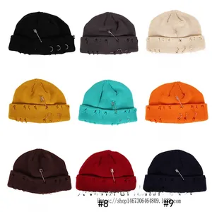Distressed knit beanies in nine colors with metal safety pin and three ring details