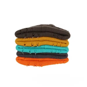 Close-up of distressed knit beanies with metal rings in five various colors stack