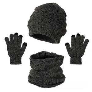 Flat lay of winter knit set including beanie, neck warmer, and touchscreen gloves