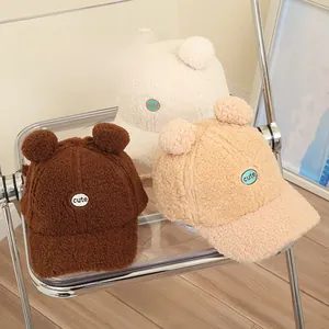 Close-up of cozy teddy fleece kids' baseball caps with bear ears and cute patch