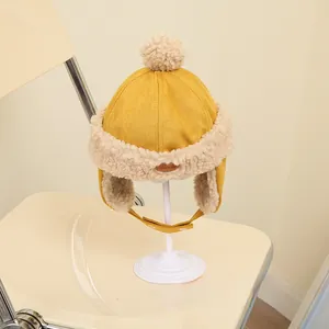 Detailed macro view of yellow winter trapper hat with soft faux shearling lining and earflaps