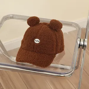 Detail of dark brown faux lamb wool kids baseball cap with cute bear ears and embroidery