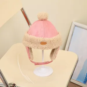 Pink lamb wool trapper hat for kids featuring earflaps and a plush pom-pom top
