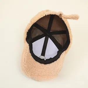 Detail view of khaki lamb wool baseball cap with black mesh lining and adjustable strap