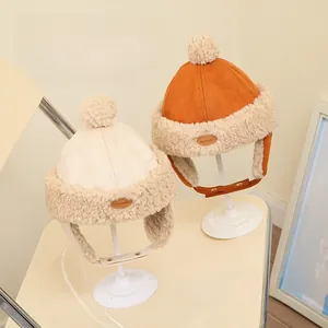 Detailed close-up of a child's winter ear-flap hat with warm faux lamb wool lining