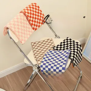 Detail view of colorful checkered knit scarves for kids in five vibrant color combinations