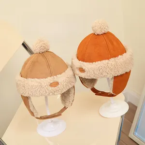 Detail view of khaki and orange thick fleece baby earflap hats with soft plush lining