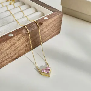 Detailed view of S925 silver heart necklace with pink zircon on a walnut jewelry box