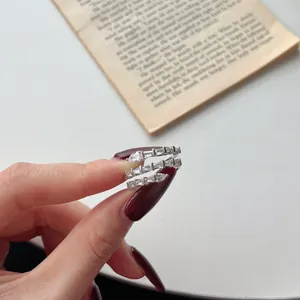Macro shot of S925 silver snake ring with baguette and pear-cut cubic zirconia stones