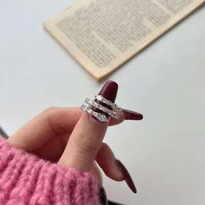 Detailed view of triple-layered silver snake ring with pear-cut cubic zirconia crystals