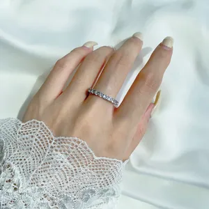 Close-up of S925 silver eternity ring with oval cubic zirconia on hand with lace
