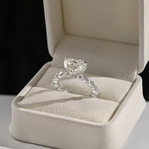 Macro shot of s925 silver heart shaped pink diamond ring with pavé stones in gift box