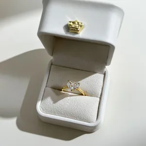 Macro shot of s925 gold-tone heart cut stone ring in a white crown jewelry box