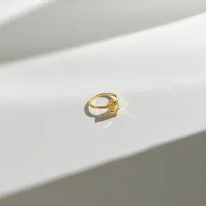 Macro shot of S925 sterling silver stamp on golden ring with yellow pear-cut stone