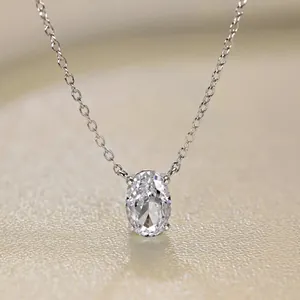 Detailed view of an oval-cut shimmering zircon pendant on a fine silver necklace chain