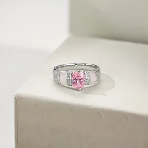 Close-up of S925 silver ring with oval pink zircon and shell inlay on stone stand