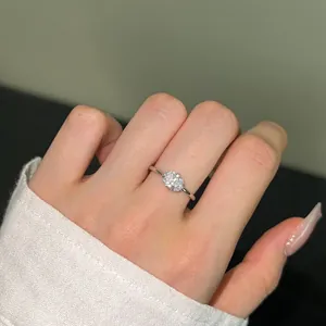 Macro shot of an oval cut zircon set on a minimalist silver ring band worn on hand