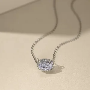 Detailed macro view of S925 sterling silver oval halo pendant necklace with cubic zirconia