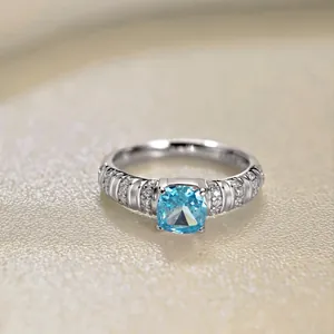 Detailed macro view of an S925 silver ring featuring a cushion-cut aquamarine gemstone