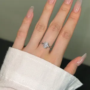 Close-up of s925 silver ring featuring an oval-cut zircon stone on woman hand