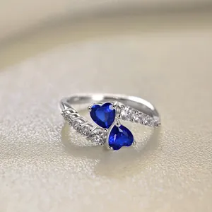 Detailed macro shot of twin blue heart-shaped zircons on an S925 sterling silver ring
