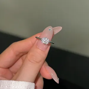 Detail of 925 sterling silver ring with oval cut white gemstone in a four-prong setting